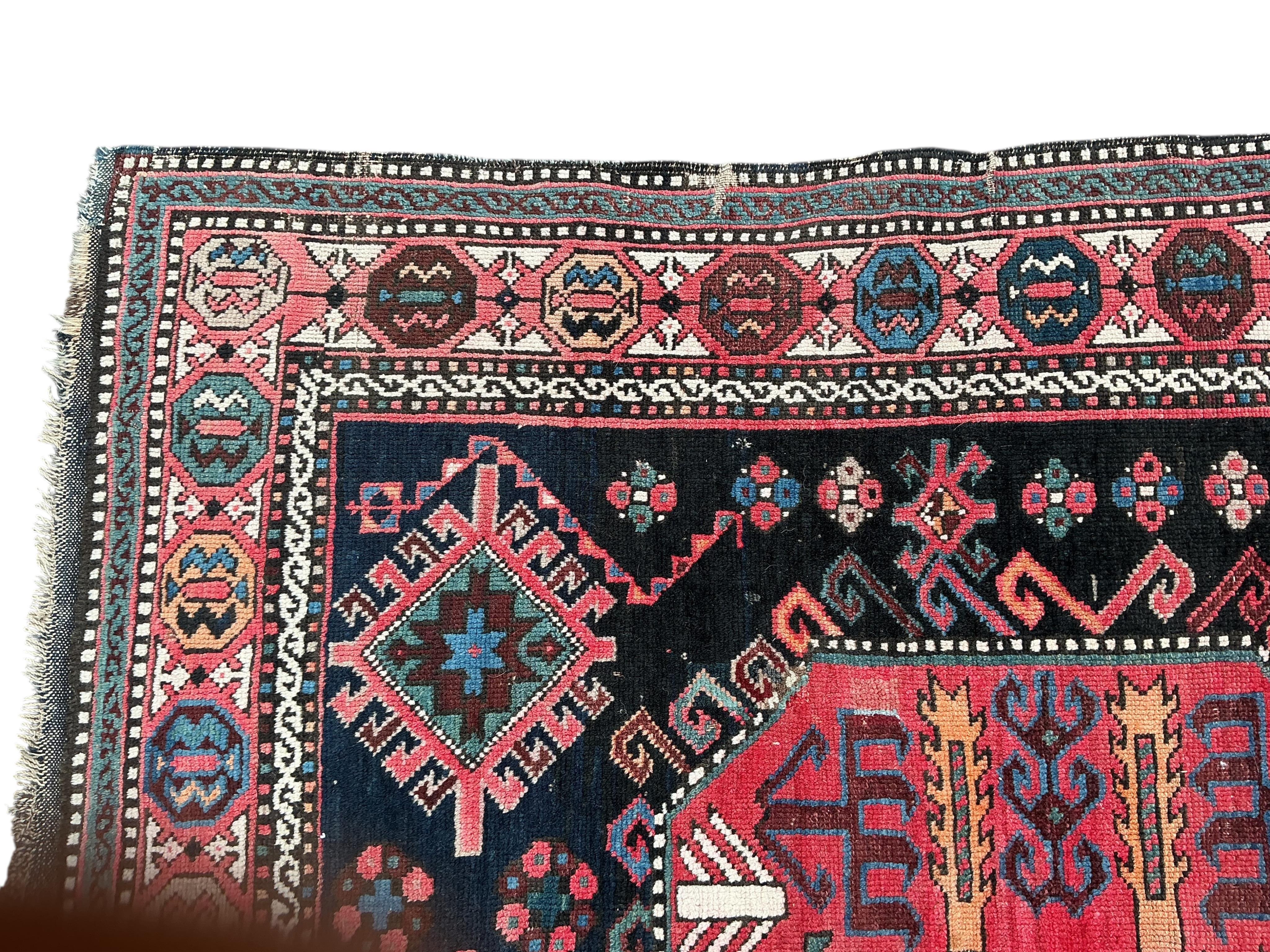 An antique Caucasian blue ground rug, 280 x 140cm
